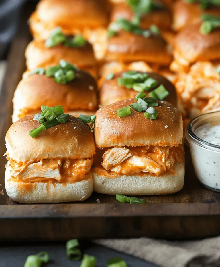 Buffalo chicken sliders topped with green onions on soft golden buns, served with a side of ranch dip.