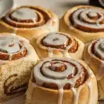Soft overnight sourdough cinnamon rolls drizzled with a sweet vanilla glaze.