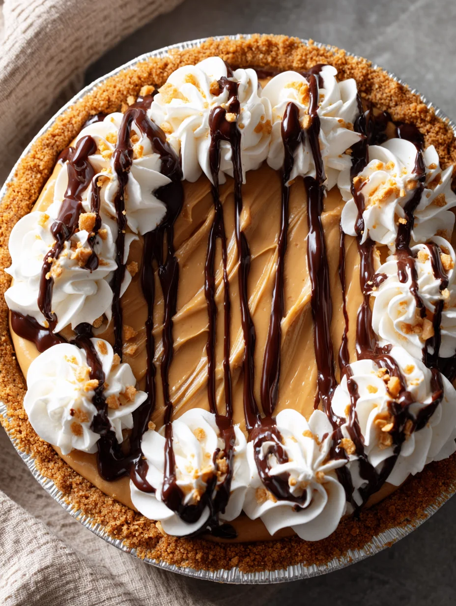 Creamy easy peanut butter pie topped with whipped cream and chocolate drizzle