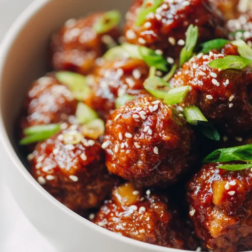 Crockpot Hawaiian meatballs in sweet pineapple sauce with green onions and sesame seeds