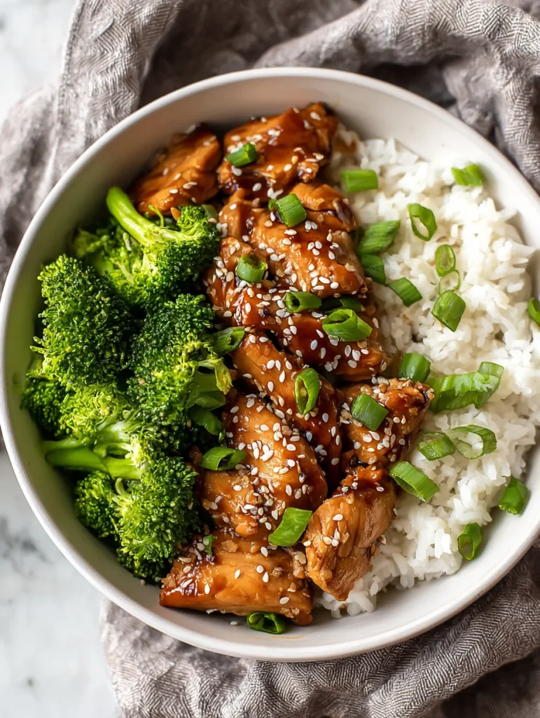 Instant Pot teriyaki chicken rice bowl with broccoli, white rice, sesame seeds, and green onions