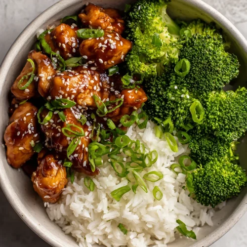 Instant Pot teriyaki chicken bowl with white rice, steamed broccoli, sesame seeds, and green onions