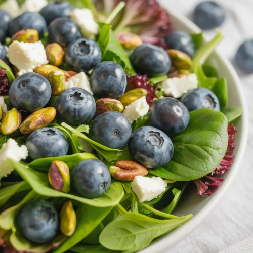 Blueberry pistachio spring salad with mixed greens, feta, and nuts