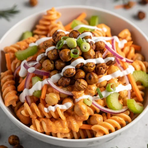 Buffalo chickpea pasta salad recipe with rotini pasta, roasted chickpeas, celery, carrots, red onion, and creamy dressing